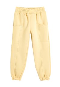 Gelbe Baumwoll-Jogginghosen mit elastischem Bund, zwei vorderen Taschen, schmal zulaufenden Bündchen und glatter Textur. Entwickelt für Komfort und einfache Tragbarkeit.