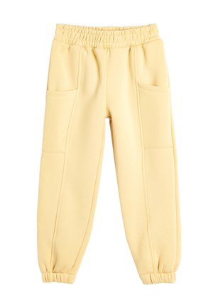 Gelbe Baumwoll-Jogginghosen mit elastischem Bund, zwei vorderen Taschen, schmal zulaufenden Bündchen und glatter Textur. Entwickelt für Komfort und einfache Tragbarkeit.