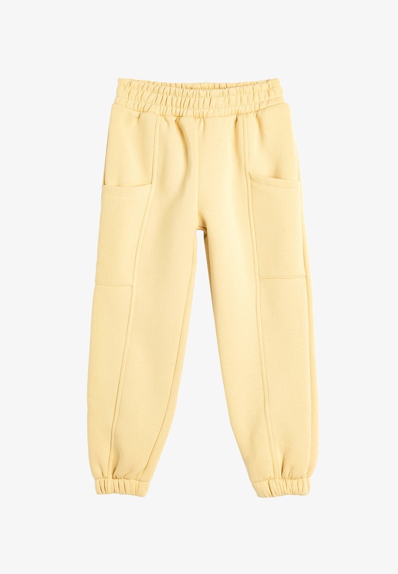 Yellow cotton joggers with an elastic waistband, two front pockets, tapered cuffs, and smooth texture. Designed for comfort and ease of wear.