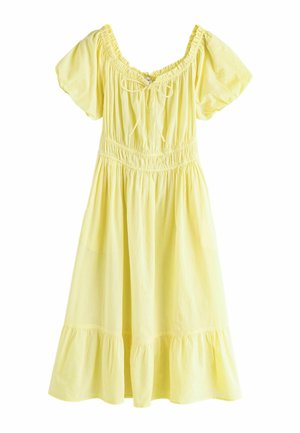 Šviesiai geltona kelio ilgio suknelė su pūstomis rankovėmis, suveržta juosmeniu, raukšlėta apačia ir priekyje rišama juostele ties kvadratine iškirpte.