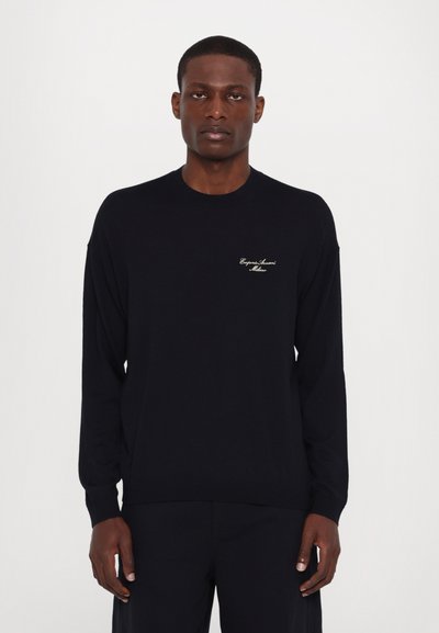 Black long-sleeve sweater made of fine knit material, featuring a crew neck and embroidered logo in gold on the left chest area.