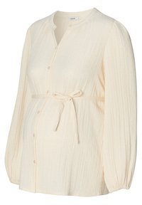 Helle cremefarbene Bluse mit Knopfleiste aus strukturiertem Stoff, langen Ärmeln und einem gerafften Bindegürtel in der Taille. Mit dezenten Musterdetails.