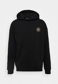 Sweat à capuche noir en mélange de coton. Comprend une poche frontale, des poignets côtelés, et un motif de lion brodé en or sur la poitrine.