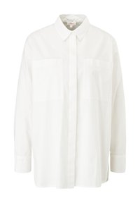 Chemise blanche en coton à boutons. Elle présente un col classique, deux poches poitrine et des manches longues avec des poignets boutonnés. Texture lisse.