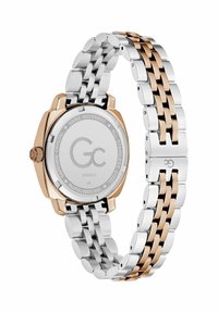 Srebrny i różowo-złoty zegarek ze stali nierdzewnej z bransoletą typu linka, okrągłą kopertą oraz gładkim cyferblatem z logo marki z tyłu.
