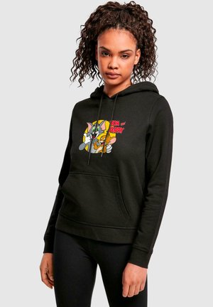 Black hoodie with a front pocket, featuring a colorful cartoon print of Tom and Jerry. Soft fabric with a relaxed fit and drawstring hood.