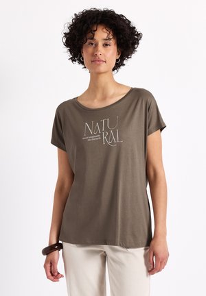 Olivově zelené tričko s krátkými rukávy, kulatým výstřihem a bílým nápisem "NATURAL" s heslem. Měkká látka, volný střih, minimalistický design.
