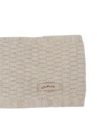 Fascia per la testa color crema lavorata a maglia con un motivo strutturato e intrecciato e un piccolo etichetta in pelle con la scritta "chic". Materiale morbido, caldo e non elastico.