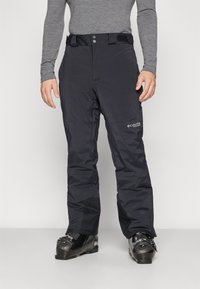 Pantalons de ski noirs avec une texture lisse et imperméable, fermeture à bouton et crochet, poches latérales, avec un logo sur la cuisse supérieure.