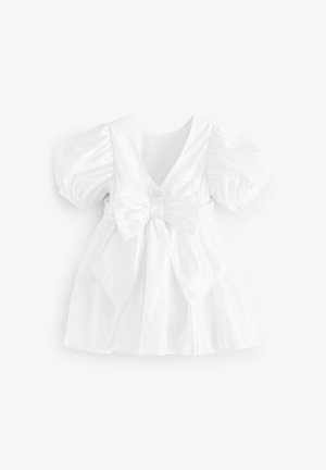 Vestido blanco con mangas abullonadas, escote en V y detalle de lazo cruzado en la cintura. Cuenta con una textura suave y un pequeño botón decorativo.