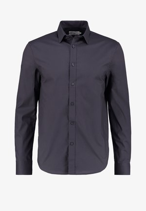 Camisa de manga larga azul marino oscura, hecha de algodón suave, con botón al frente, cuello clásico y un corte ajustado.