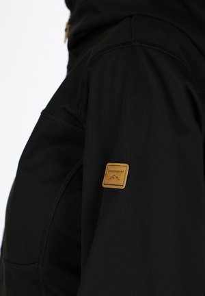 Black outerwear jacket with a textured finish, featuring a brown leather tag and visible stitching details on the shoulder.