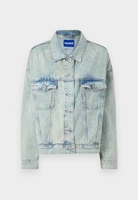 Light blue denim jacket with a cropped design, two chest pockets, silver buttons, and subtle logo pattern throughout.