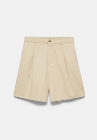 Short beige clair taille haute avec plis, passants de ceinture, bouton devant, fermeture éclair et poches latérales sur fond blanc.