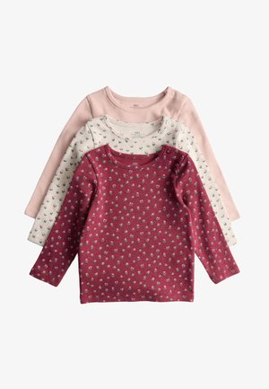 Set di tre magliette a maniche lunghe in rosa pastello, crema con motivo floreale e bordeaux con piccole stampe di fiori; texture a costine.