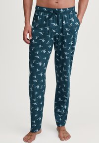 Heren pyjamabroek in teal stof met een algeheel vogelprint. Heeft een elastische tailleband met een trekkoord en zijzakken.