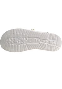 White rubber shoe sole featuring a textured pattern with grooves and star accents, labeled "HEY DUDE" in the center.