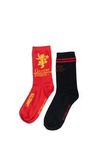 Rote und schwarze Socken mit "Game of Thrones" Branding. Die rote Socke hat ein Löwenmotiv und den Text "LANISTER", während die schwarze Socke rote Streifen hat.