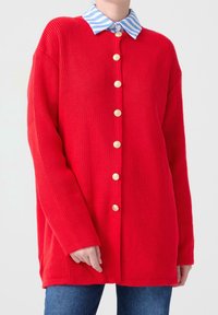 Red ribbed cardigan with gold-tone buttons and a blue and white striped collar. Lightweight fabric and relaxed fit with long sleeves.