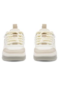 Białe i beżowe sneakersy z teksturowanym zamszem i gładką skórą. Masywna podeszwa z jasnoszarymi rowkami i grubymi, kremowymi sznurówkami.
