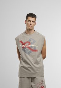 Light gray sleeveless t-shirt with a round neckline, featuring multicolored graphic designs in red and blue on the front. Soft cotton blend.