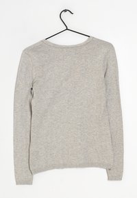 Grå långärmad tröja med rund halsringning, slät textur och ribbade muddar. Hänger på en svart metallgalge mot en vit bakgrund.