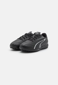 Scarpe sportive nere realizzate in materiale sintetico, con punta arrotondata, design con lacci e accenti bianchi sui lati. Suola in gomma texturizzata.