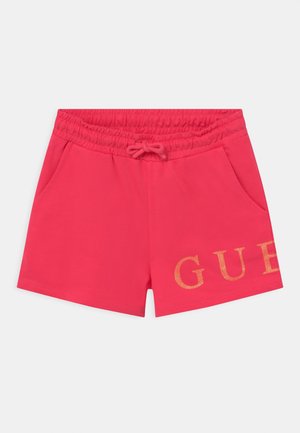 Lys pink shorts med elastisk linning, snøre, to sidelommer og gyldent GUESS-logo på venstre forben.