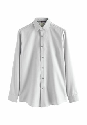 Light gray button-up shirt with long sleeves, a collar, and a smooth texture. Features six buttons down the front and rounded hem.