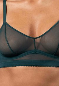 Türkiser Netz-Bralette mit verstellbaren Trägern, V-Ausschnitt, gewelltem Saum und einem weichen Unterbrustband für Komfort und Unterstützung.