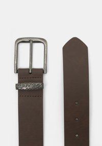 Brown leather belt featuring a silver-tone metal buckle with a unique engraved design, and a pointed end with multiple adjustment holes.