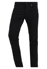 Svarta denimbyxor med en åtsittande design, fem fickor och knäppning fram. Slät yta med minimala sömdetaljer.