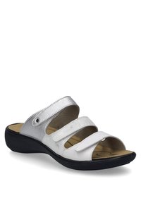 White and silver sandals with three adjustable Velcro straps, a cushioned insole, and a black rubber sole; smooth and metallic textures.