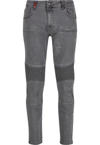 Szürke slim-fit farmer bordázott térdpanelek, kopott részletek a combokon és a térdeken, elülső gomb, cipzáras záródás és ötlukú kialakítás.