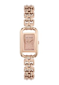 Roosa kuldne ristkülikukujuline randmevariant, millel on sädelev kellakupee ja ketaskett, brändinimi "Ted Baker" kellakupes.