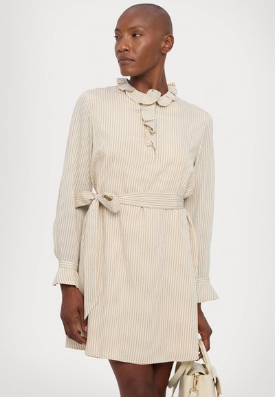Beige striped dress with a ruffled collar, long sleeves, and a tied waist belt. Soft fabric with a straight cut and flared sleeve cuffs.
