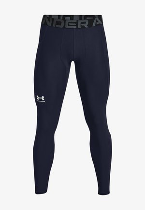 Navy compression leggings with a textured black waistband featuring "UNDER" and a white logo on the left thigh. Stretchy, fitted design.