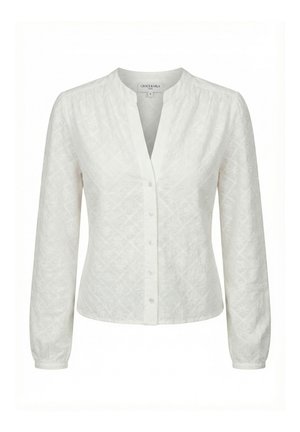Blouse blanche à manches longues avec broderie florale subtile, fermeture boutonnée sur le devant, col rond et manches longues légèrement froncées avec poignets.