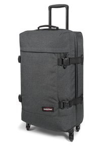 Large dark gray wheeled suitcase with a textured fabric, two compression straps, and a retractable handle, featuring an Eastpak logo.