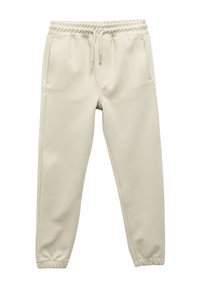 Beige joggingbroek met een elastische tailleband en trekkoord, voorzien van twee zijzakken, taps toelopende pijpen en een gestructureerde stofafwerking.