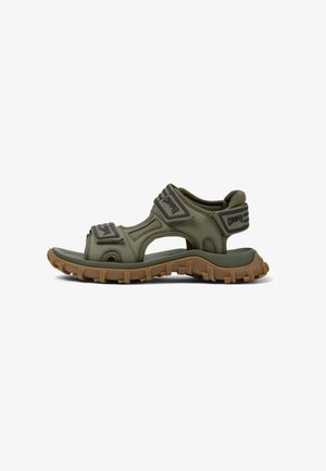 Gröna sandaler med stängd tå, öppna sidor, justerbara remmar och en texturerad gummisul för bättre grepp.