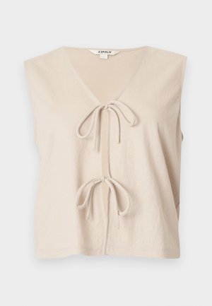 Haut beige sans manches avec un profond décolleté en V et deux nœuds noués sur le devant, fabriqué dans un tissu doux et léger.