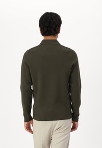 Olive green knitted pullover with a flat collar, long sleeves, and a fitted shape. The texture appears smooth and soft against a plain background.