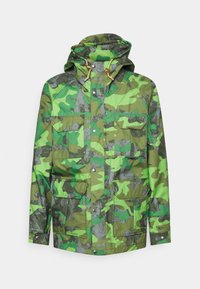 Green camo jacket with a hood, featuring multiple flap pockets, snap closures, and a mix of matte and shiny textures.