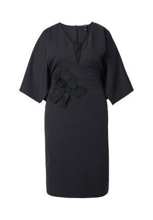 Schwarzes knielanges Kleid mit weiten dreiviertel Ärmeln, V-Ausschnitt und großer schwarzer Blumenapplikation an der linken Taille.