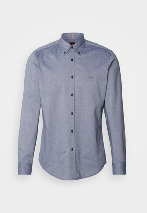 Blue button-up shirt in a lightweight fabric. Features a spread collar, long sleeves, and a small logo on the chest. Front button closure.