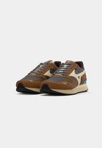 Brown and gray athletic shoes with a suede and mesh upper, featuring a light-colored midsole and turquoise accents. Laced design.