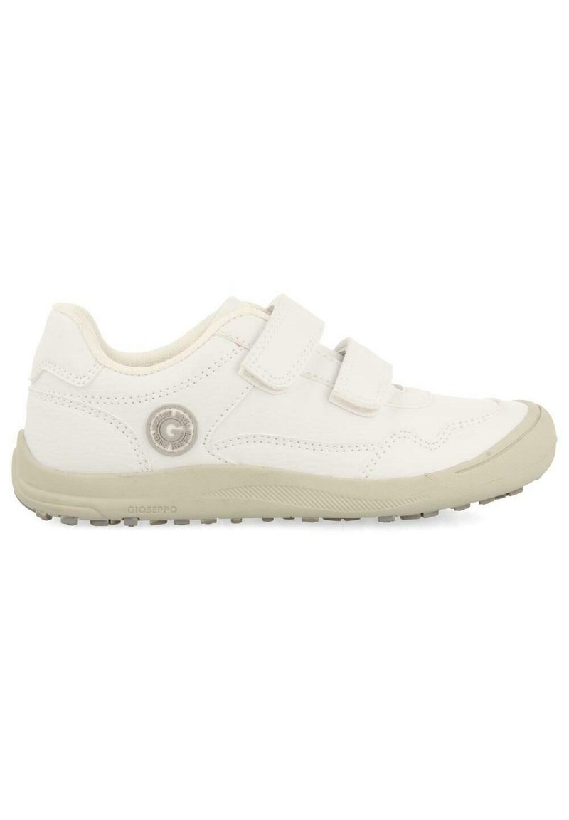 Baskets blanches avec deux bandes Velcro, en matériau supérieur lisse, bout rond et semelle en caoutchouc beige clair avec une texture antidérapante. Détail de la marque Gioseppo.