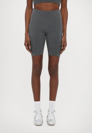 Gray, stretchy biker shorts with a high waistband, made of soft fabric. Paired with silver ballet flats and white socks.
