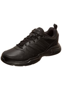 Black athletic shoe made of textured leather with mesh accents. Features a cushioned sole, lace-up front, and branded logo on the tongue.